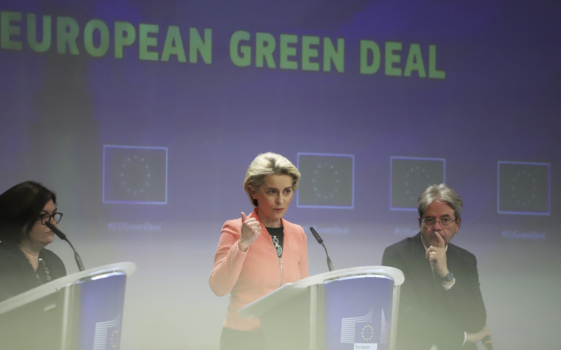 European Commission President Ursula von der Leyen, center, speaks during a media conference at EU headquarters in Brussels, Wednesday, July 14, 2021. The European Union is unveiling Wednesday sweeping new legislation to help meet its pledge to cut emissions of the gases that cause global warming by 55% over this decade, including a controversial plan to tax foreign companies for the pollution they cause. (AP Photo/Valeria Mongelli) BRU126