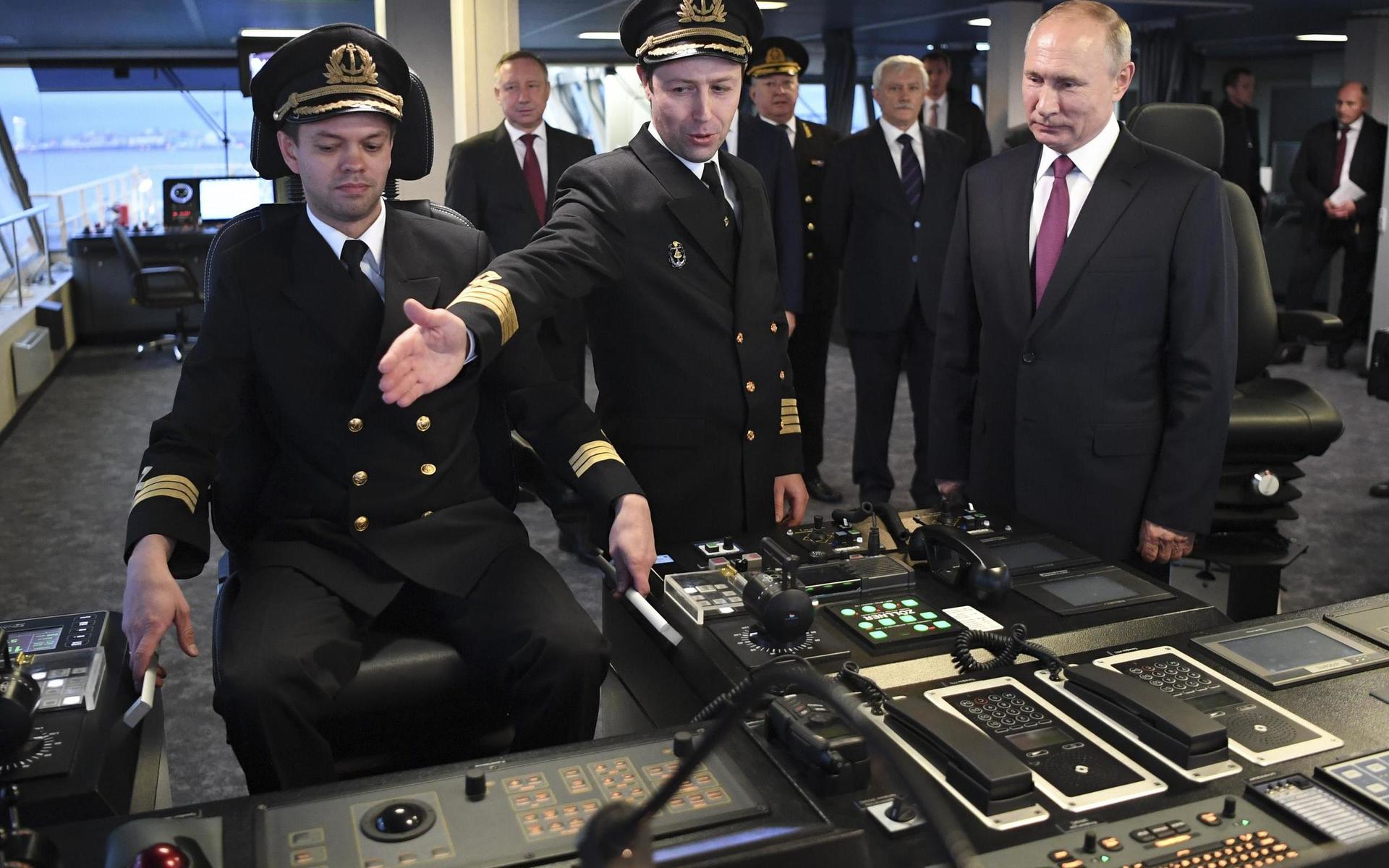 Russian President Vladimir Putin, right, visits the captain's bridge of the newly built diesel-electric icebreaker "Viktor Chernomyrdin" in St. Petersburg, Russia, Tuesday, Nov. 3, 2020. Putin said that Russia will expand its fleet of icebreakers as part of its efforts to develop the Arctic territories. (Alexei Nikolsky, Sputnik, Kremlin Pool Photo via AP) XAZ103